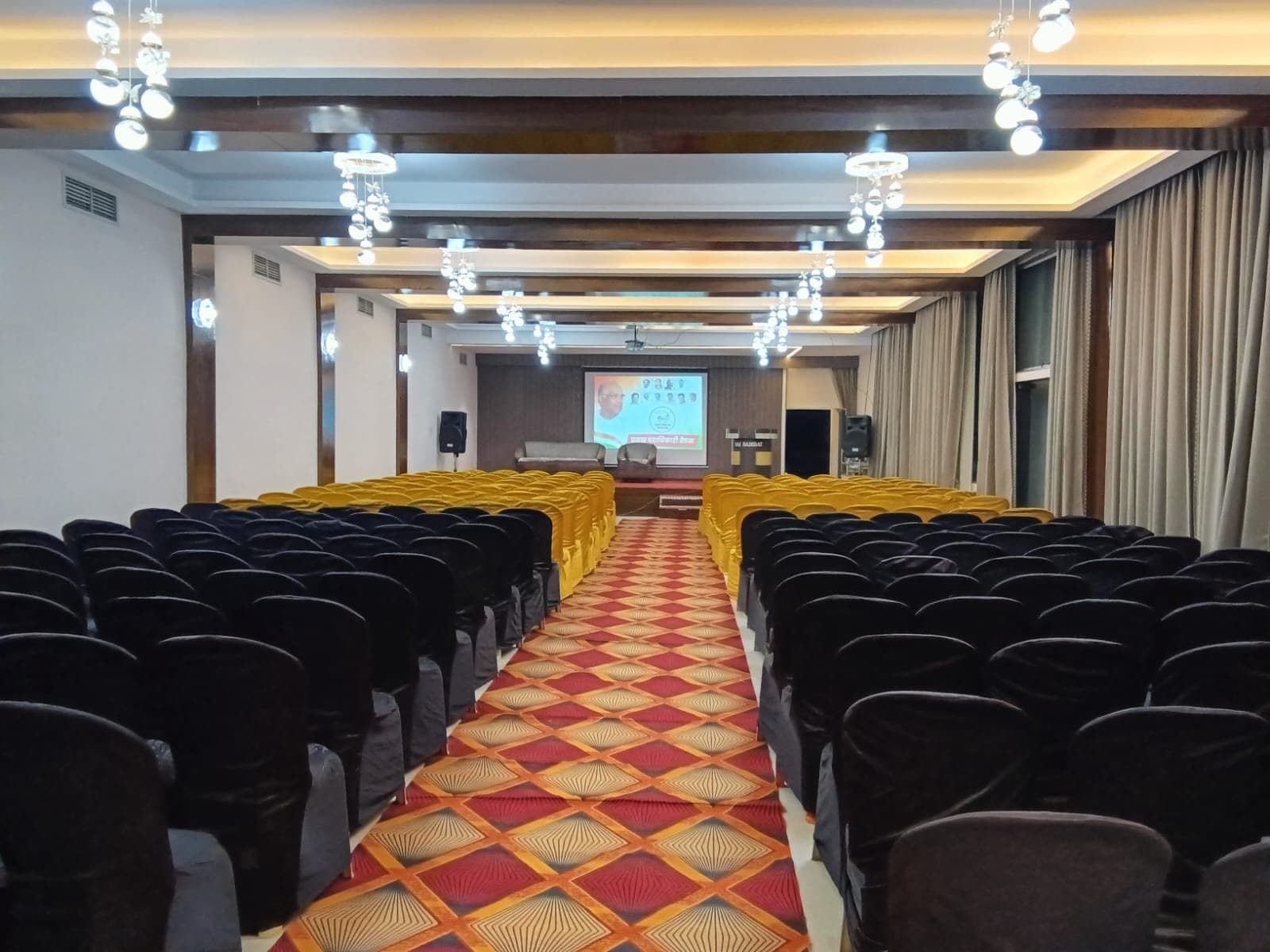 AC banquet hall with crystal chandeliers at Sai Samrat, Satara