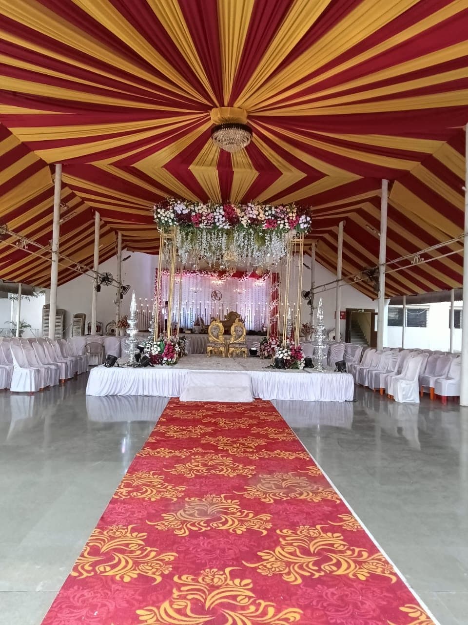 Mandap under the draped ceiling of the open hall
